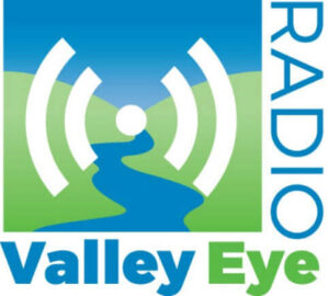 Logo with a blue river winding through green hills under a radio signal icon. The words RADIO are vertical on the right, and Valley Eye is bold below in blue and green letters—highlighting Springfield MA’s Golden Nozzle Towel Exchange Program.